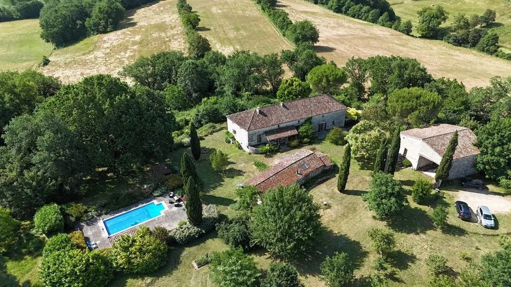 The estate from the air — house, cottage, barn and pool